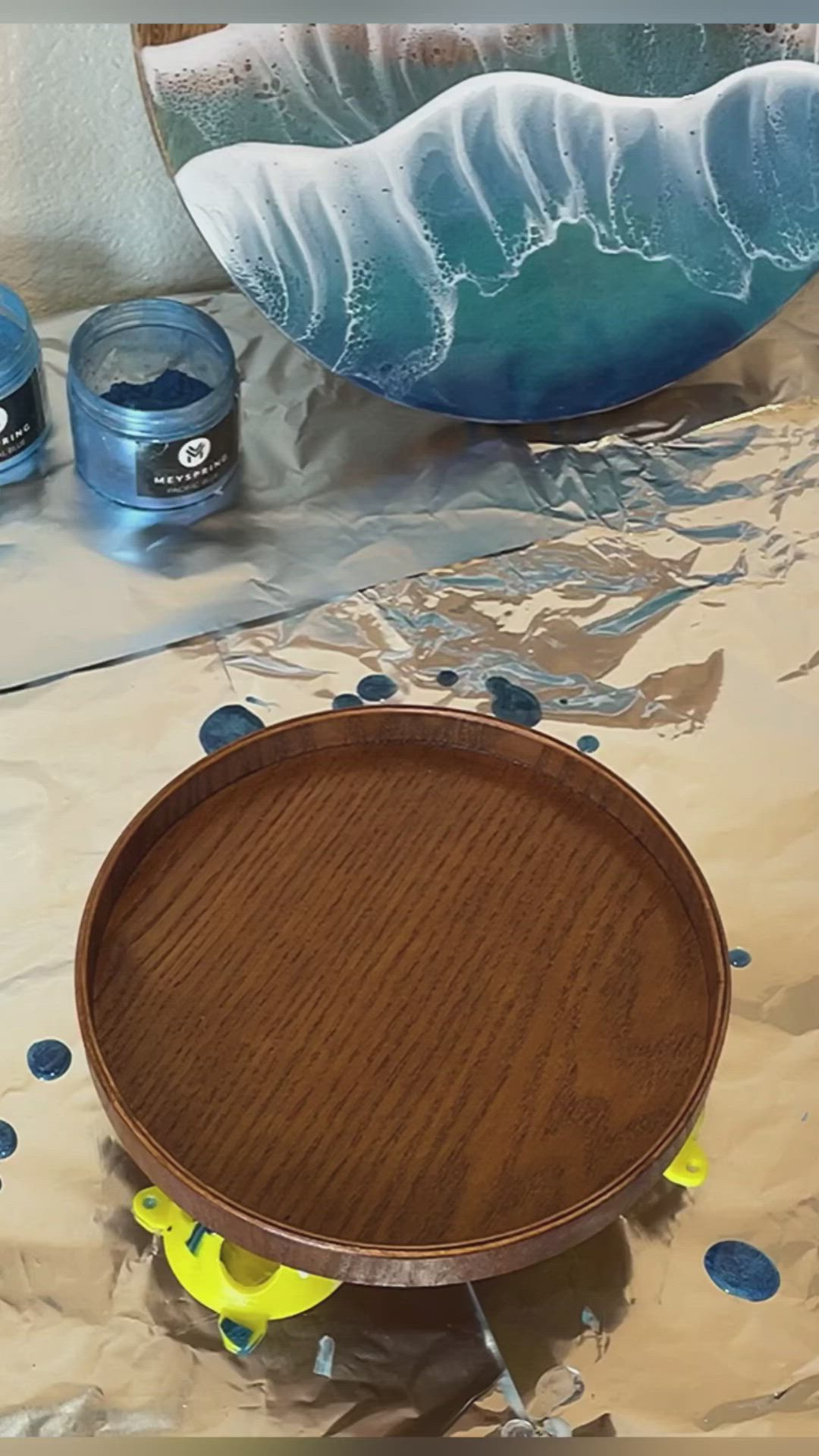 This may contain: a close up of a wooden bowl with blue and white paint on the inside of it