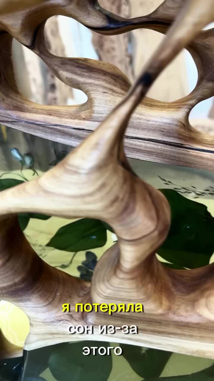 This may contain: a glass and wood table sitting on top of a white counter