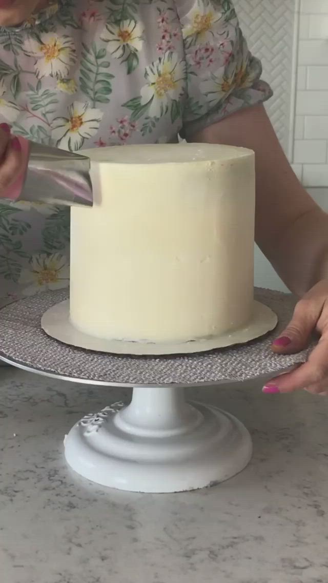 This may contain: a multicolored cake sitting on top of a white plate