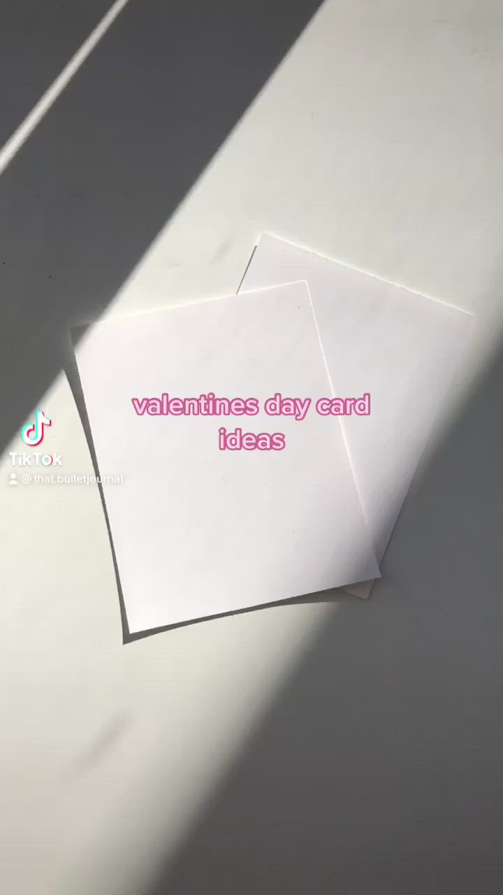 This may contain: two valentine cards with hearts hanging from strings