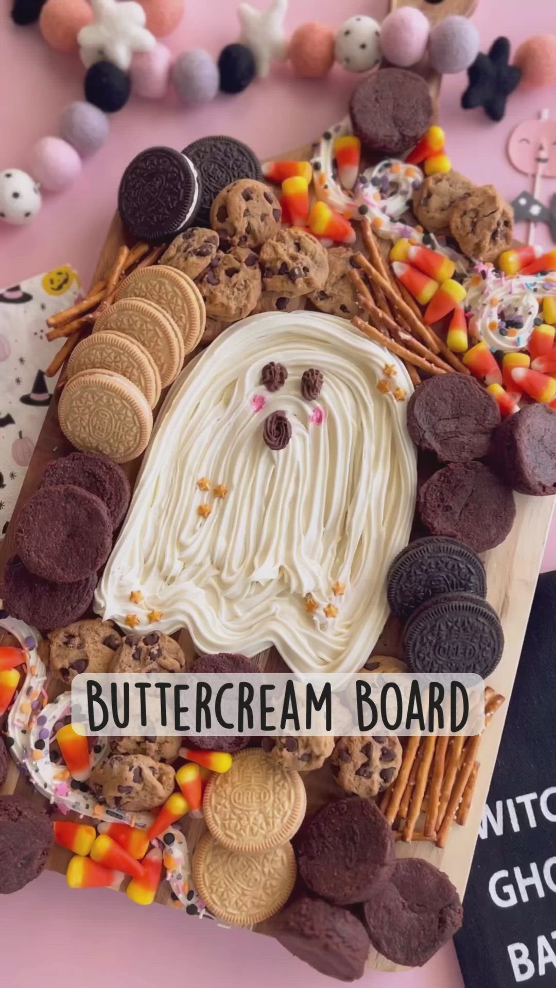 This may contain: a plate with cookies, marshmallows and candy on it that says buttercream board