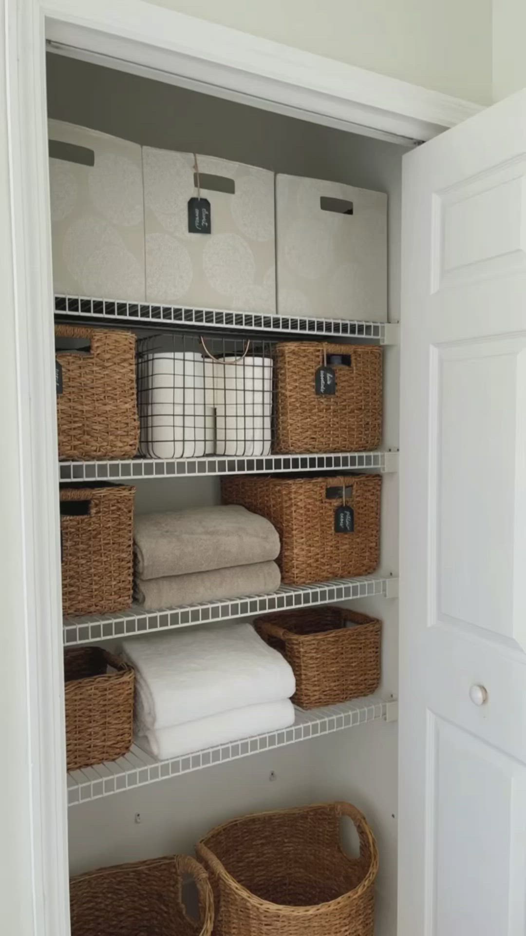 This may contain: an organized closet with baskets and towels