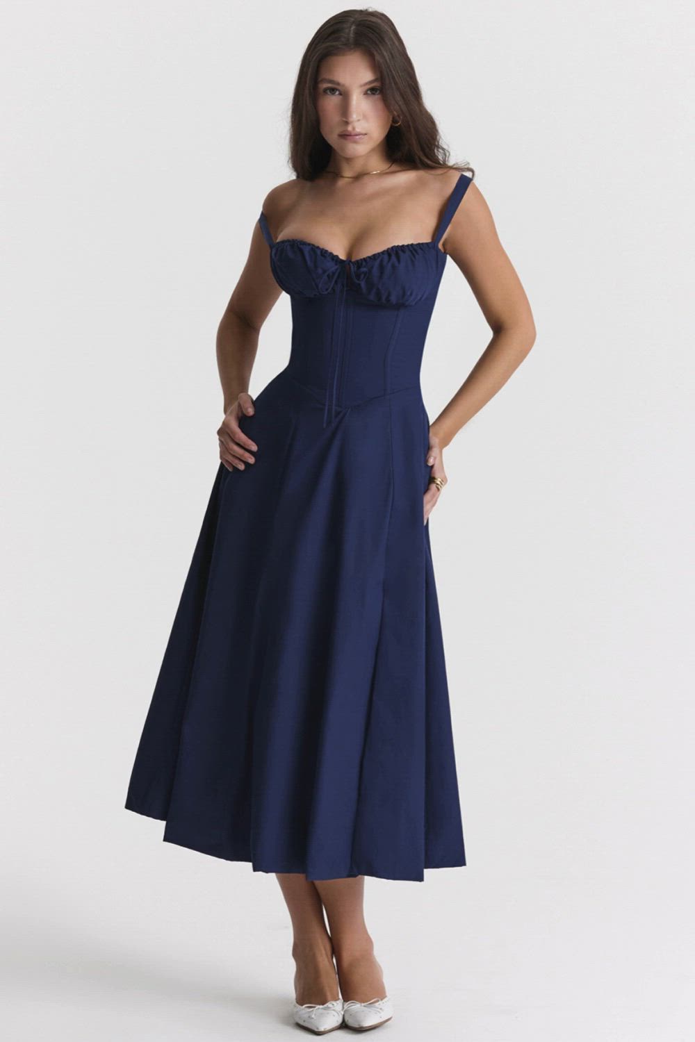 This contains: Experience elegance and sophistication with our Spaghetti Strap Sleeveless A-line Midi Dress. Crafted with a flattering backless design, this dress is perfect for any occasion. The lightweight fabric and A-line silhouette provide a comfortable and elegant fit. Elevate your fashion sense with our stylish and versatile slipdress.