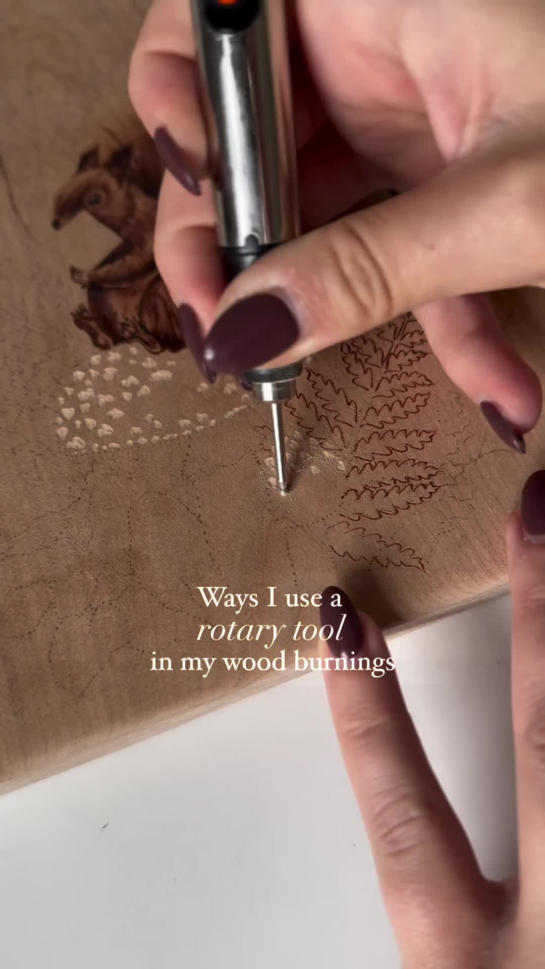 This may contain: a woman's hands holding a pen and writing on a piece of paper with the words, ways i use a rotary tool in my wood burning