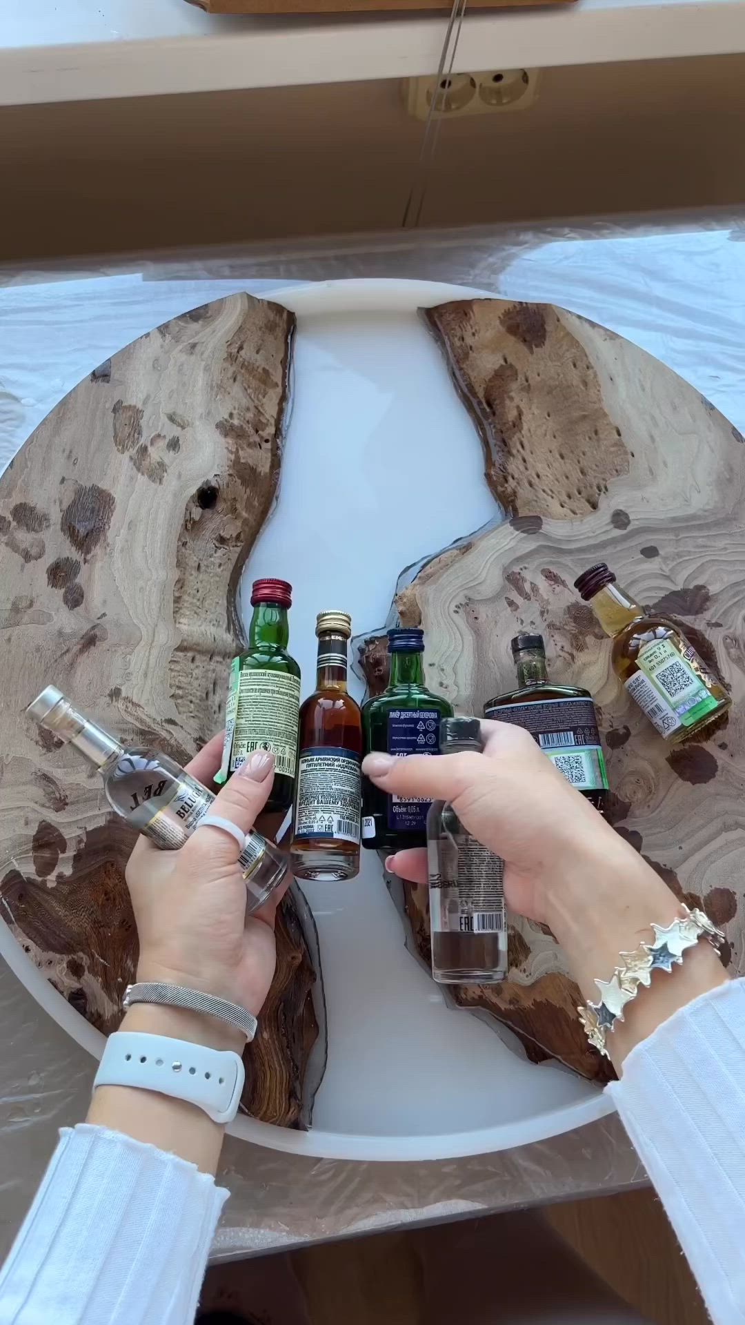 This may contain: a wooden table with bottles and cans on it