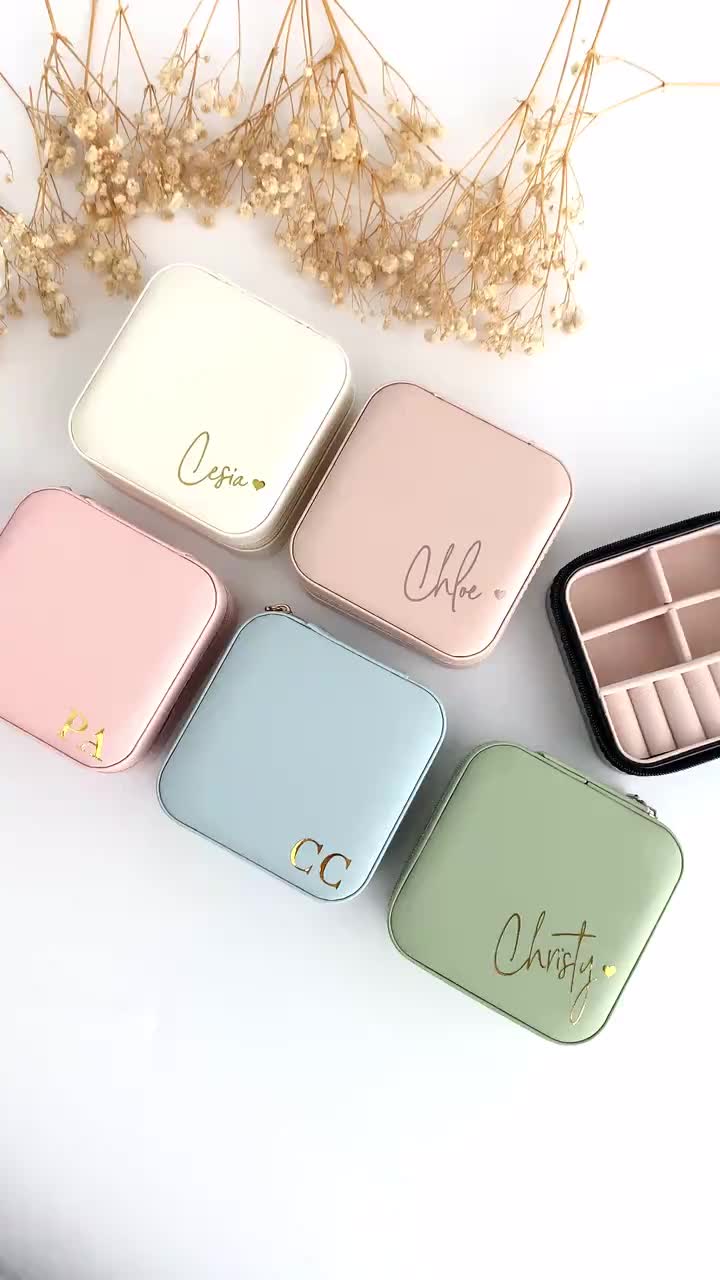 This may contain: four different colors of compact boxes with the word ope written on one side, and two