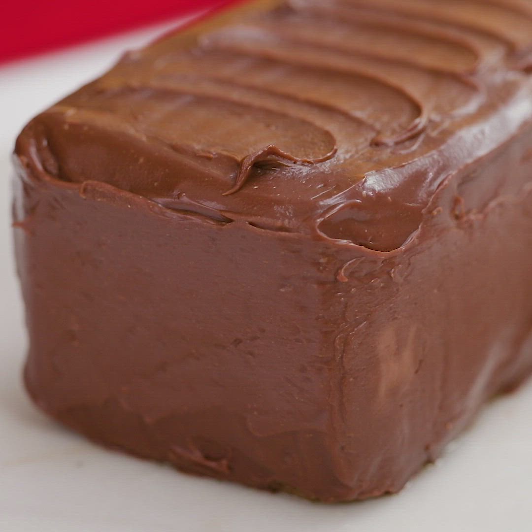 This may contain: a piece of chocolate cake sitting on top of a white plate