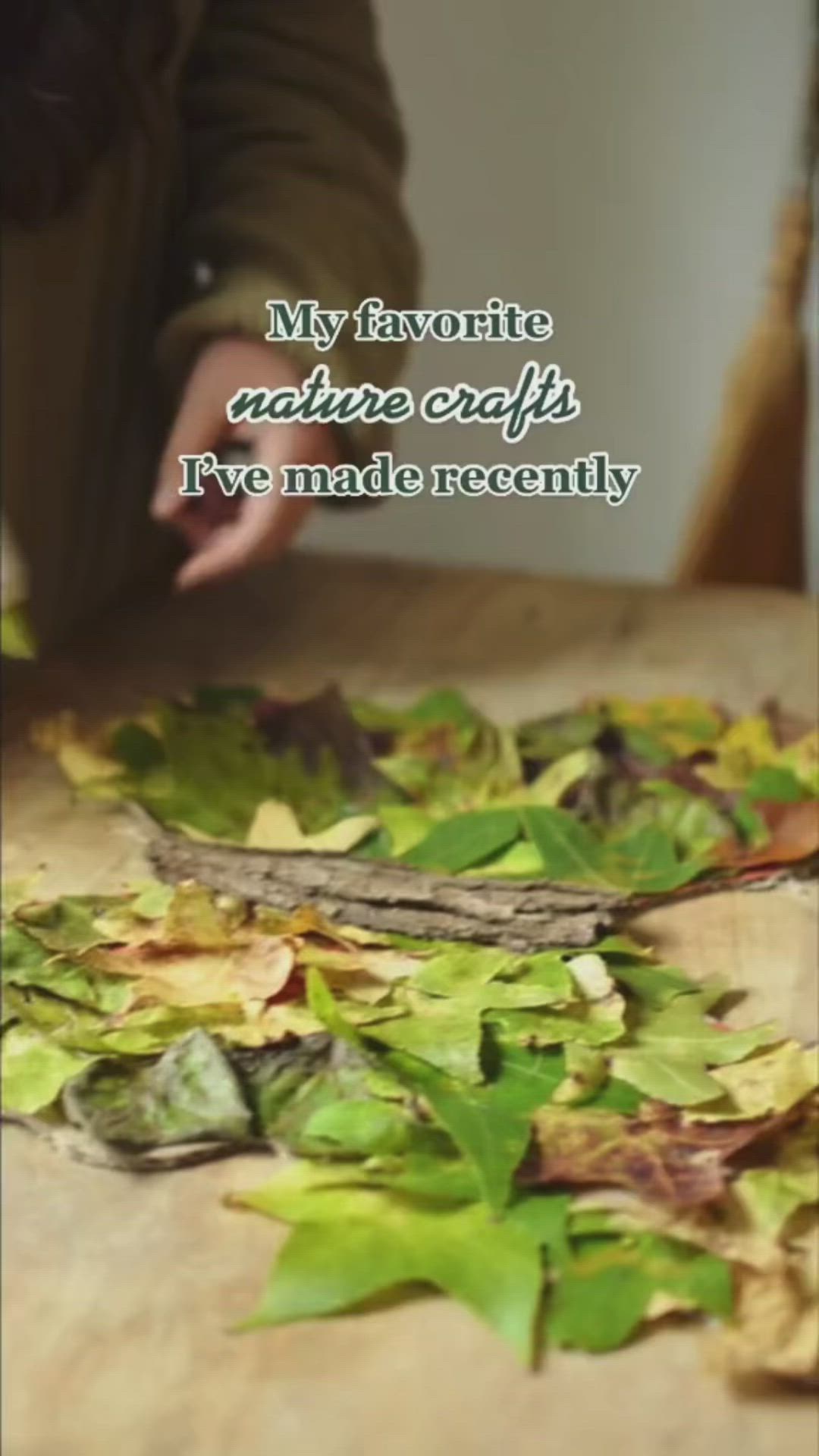 This may contain: a table with leaves on it and a person sitting at the table in the background