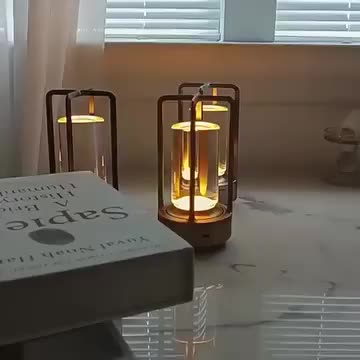 This may contain: three lit candles sitting on top of two books and one candle is turned yellow in the middle