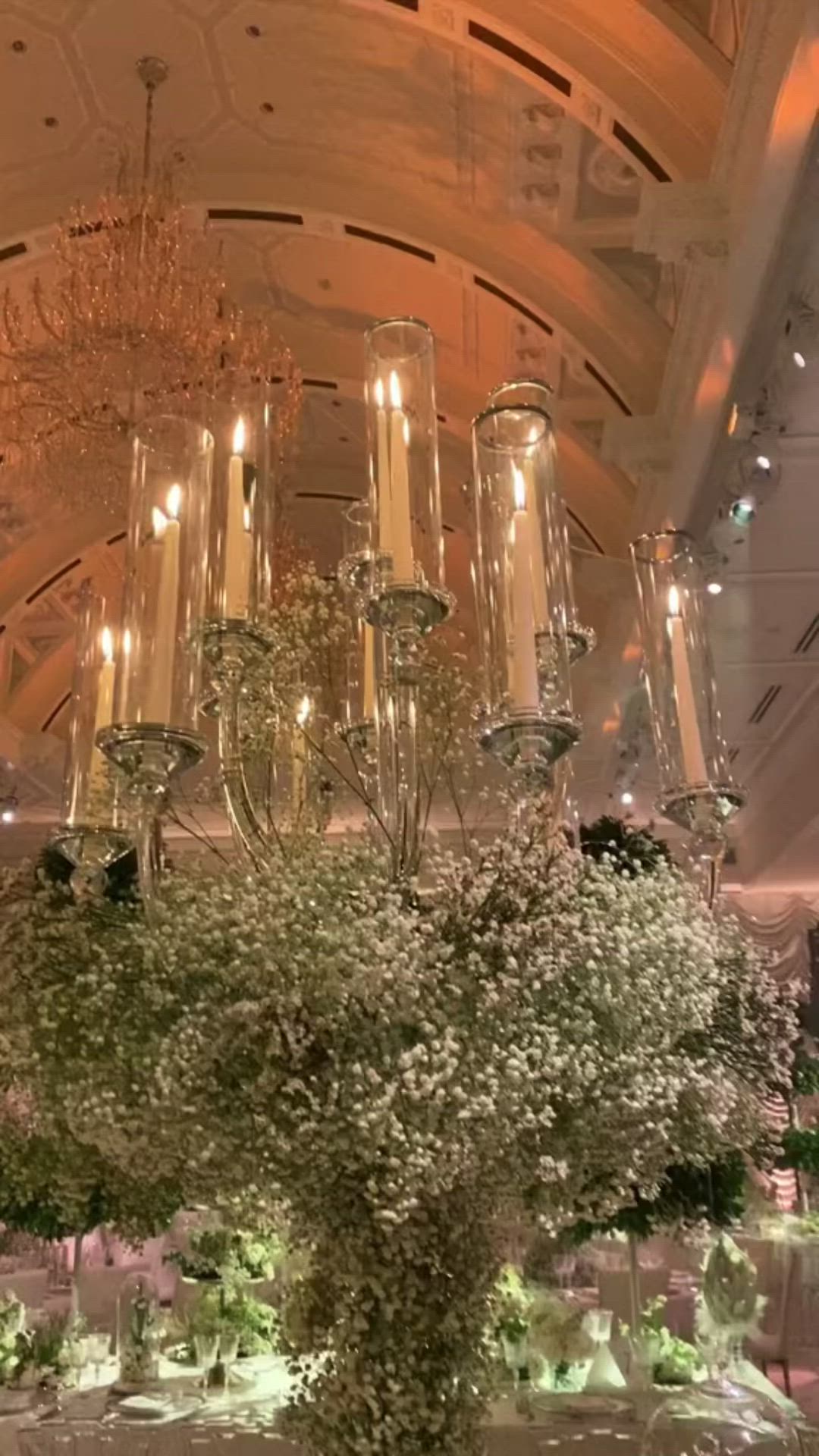 This may contain: the centerpiece is made out of glass vases and baby's breath flowers