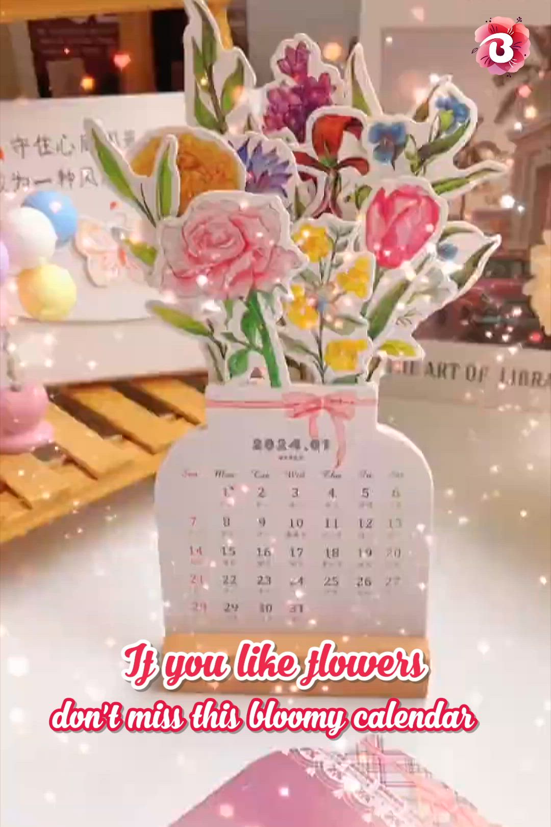 This may contain: a calendar with flowers in it sitting on a table next to a box filled with candy