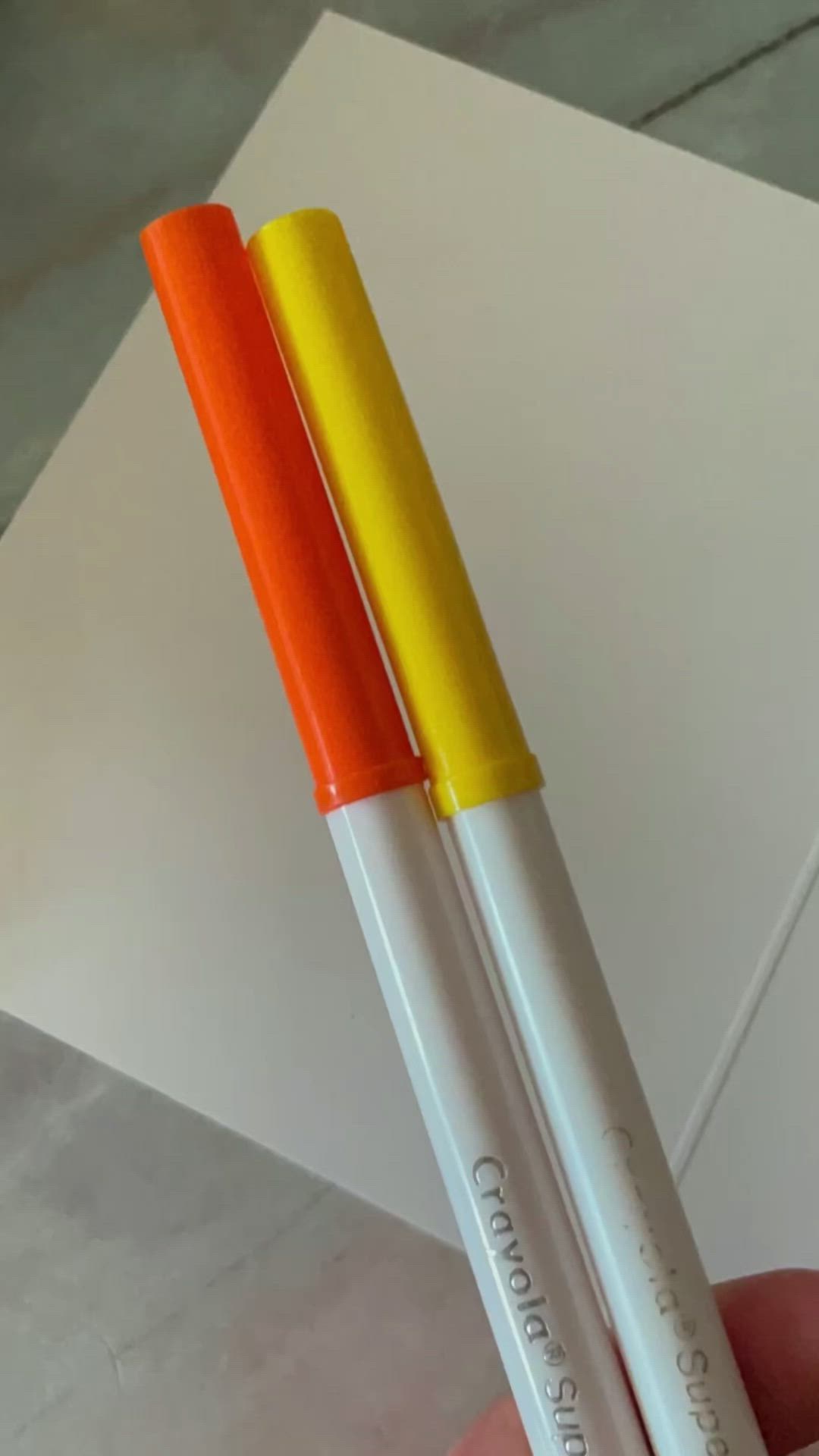 This may contain: two orange and white pens sitting next to each other