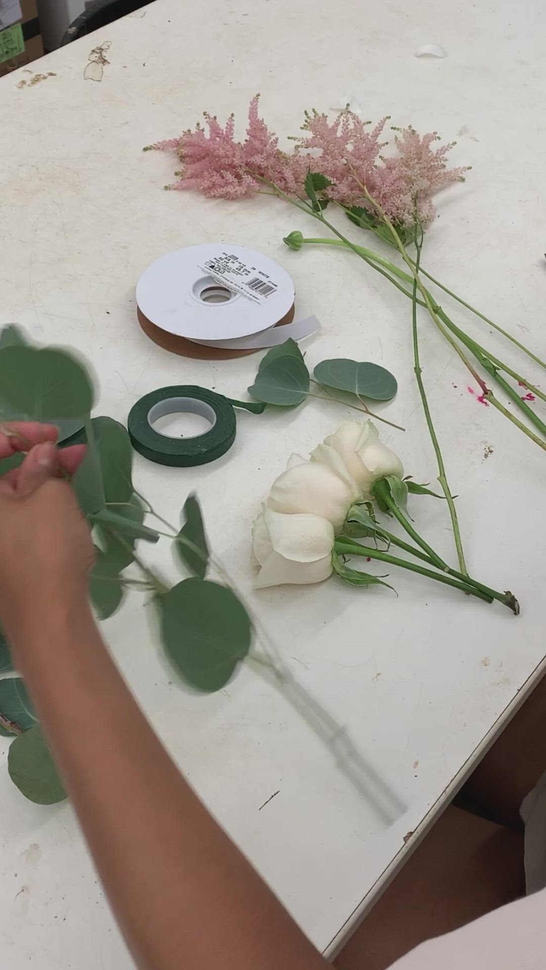 This may contain: someone is making flowers out of leaves on a table