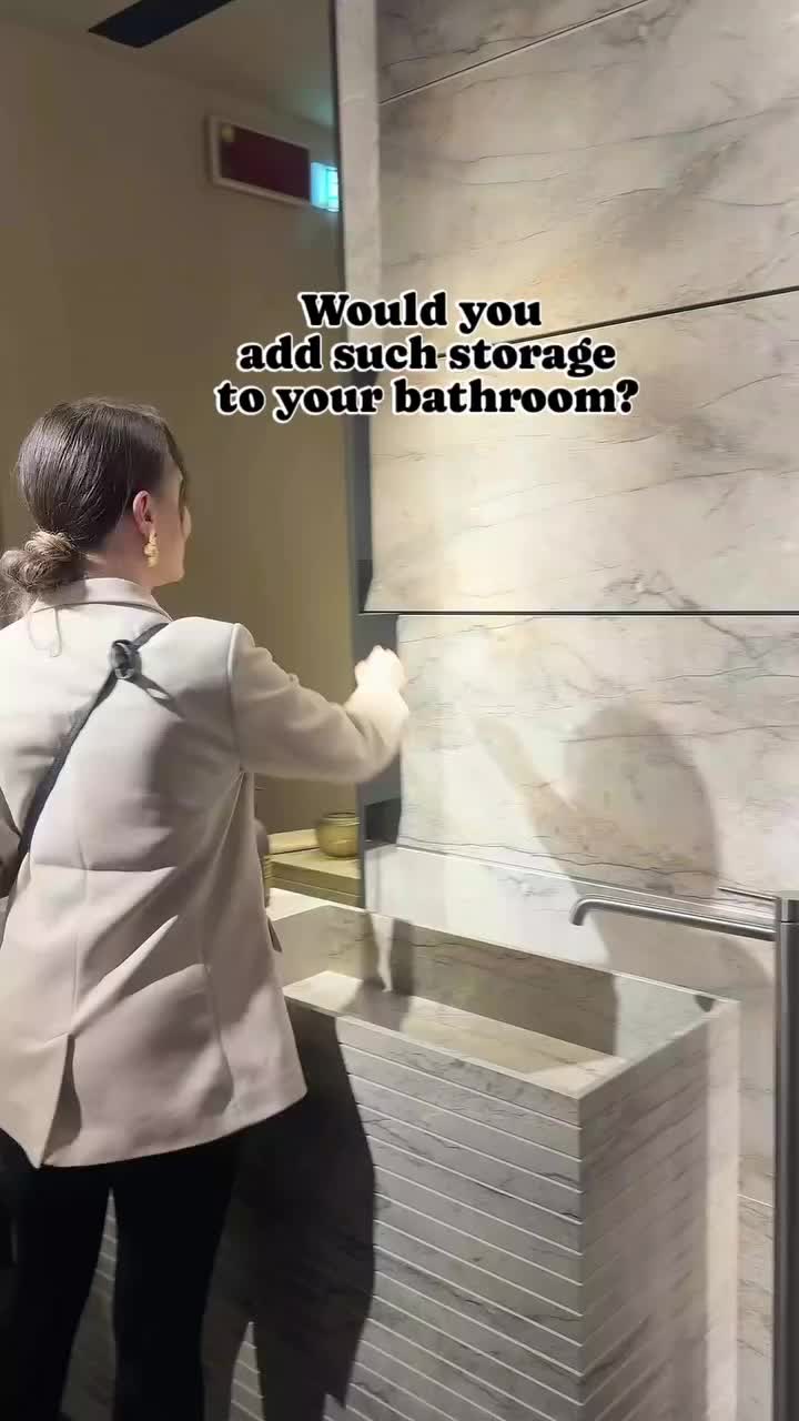 This may contain: a woman standing in front of a bathroom mirror next to a sink with the words would you add advantage to your bathroom?