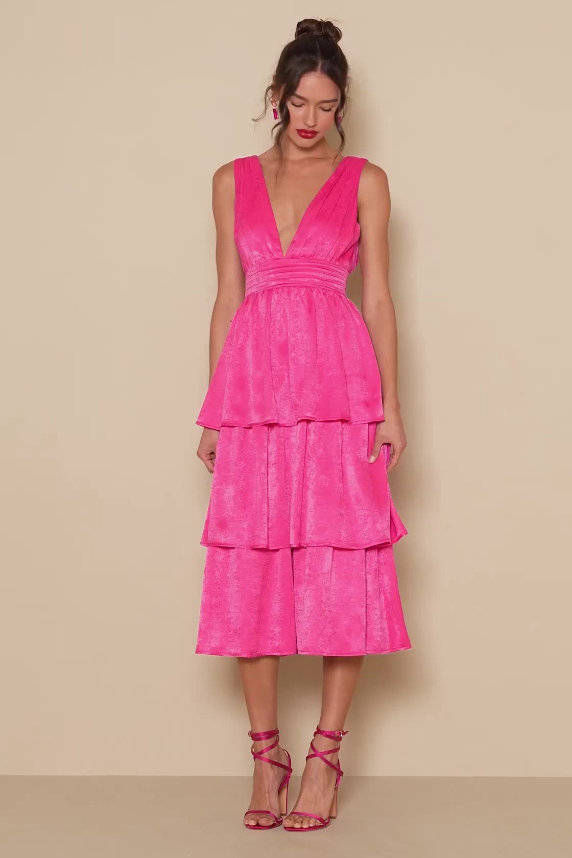 Be the best dressed at your next soiree in the Lulus Peak Party Vibe Hot Pink Satin Tiered Tie-Back Midi Dress! Sleek satin shapes this dress that has wide straps that flow into the gathered bodice and frame a plunging V-neckline (and back). A banded waist ties together at back and tops a flouncy, tiered midi skirt. Hidden back zipper/clasp. Fit: This garment fits true to size. Length: Mid-calf length. Size medium measures 48" from shoulder to hem. Bust: Great for any cup size. Waist: Fitted - v