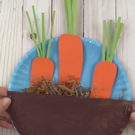 This may contain: a paper plate with carrots and grass in it