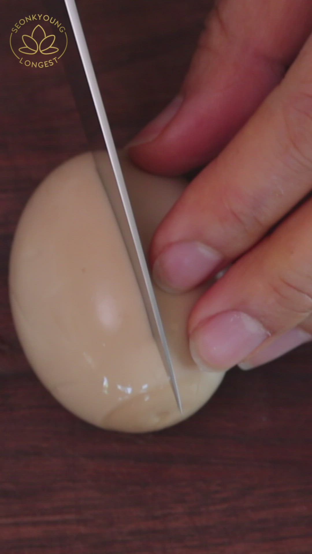 This may contain: someone is peeling an egg into pieces on a wooden table with a knife and fork