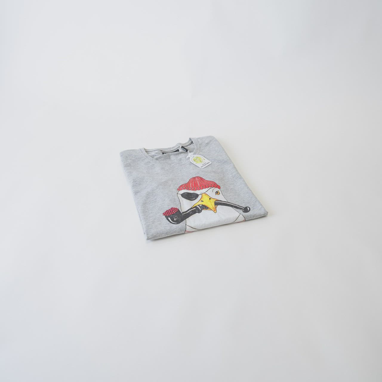 This may contain: a t - shirt with an image of a bird on it