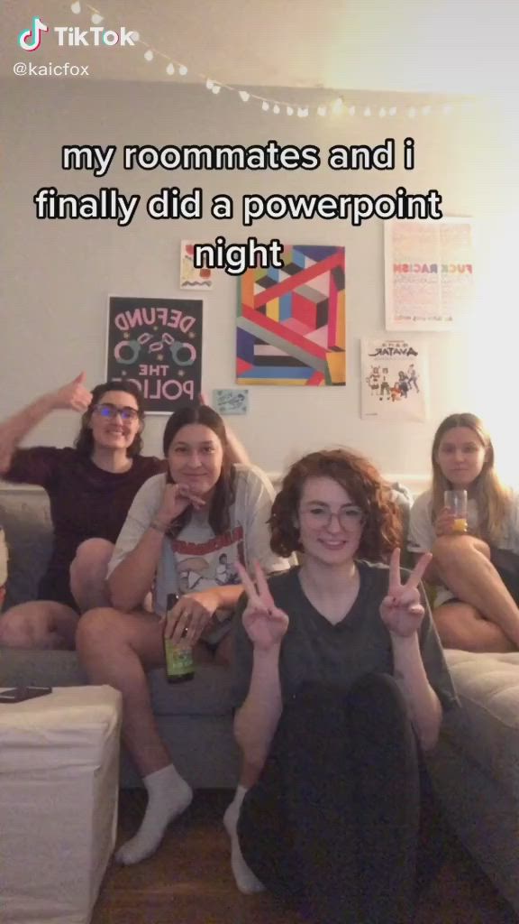 This may contain: a group of women sitting on top of a couch in front of a wall with the words my roommates and i finally did a powerpoint night