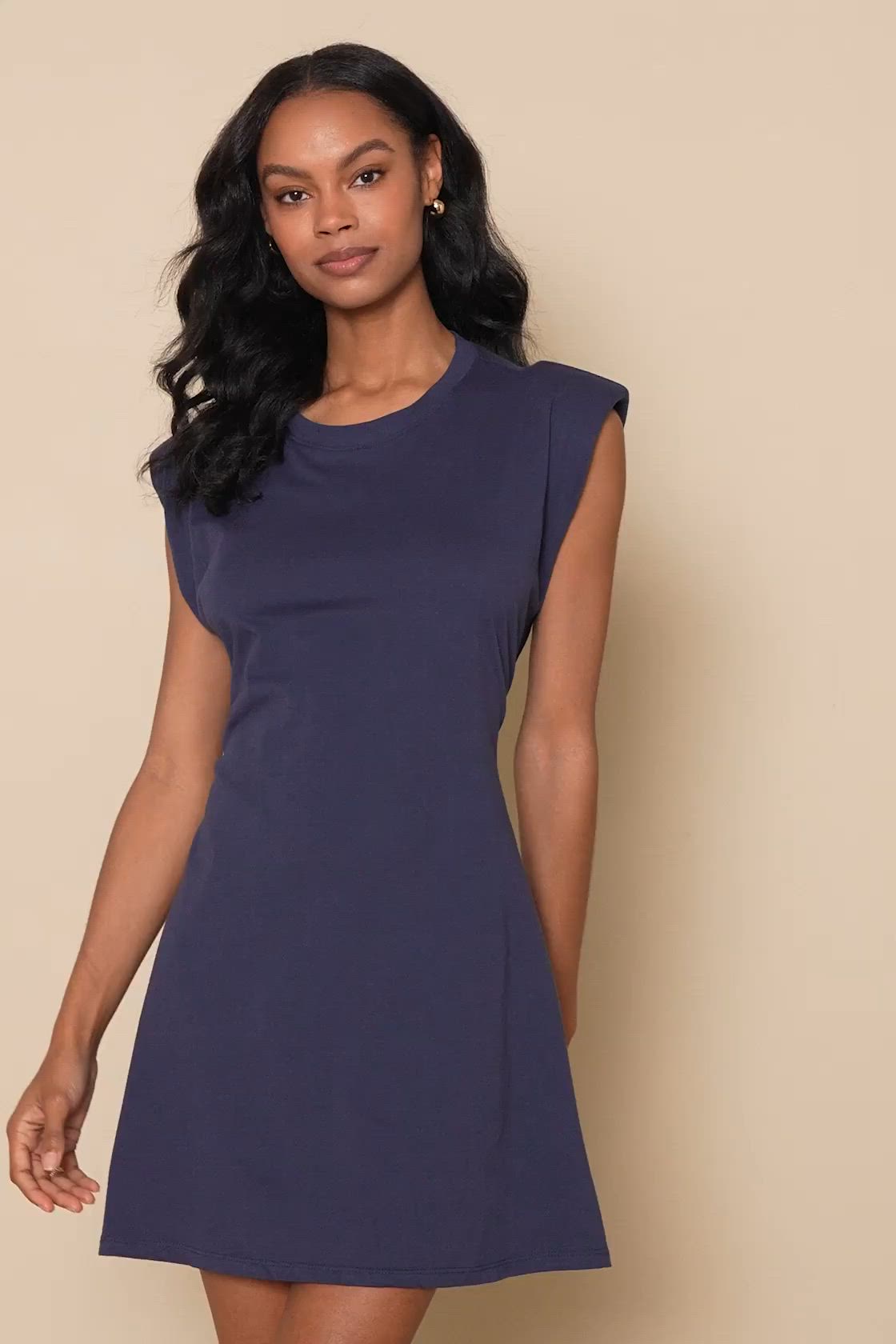 Get ready to make a power move in the Lulus Feelin' Confident Navy Blue Cutout Mini Shirt Dress! Comfortable cotton stretch knit shapes this dress that has a crew neckline and sleeveless bodice with padded shoulders that make a statement! The t-shirt silhouette continues down to a mini hem. A cutout at the back adds a flirty finish. Elastic at back for fit. Fit: This garment fits true to size. Length: Above mid-thigh. Size medium measures 35.5" from shoulder to hem. Bust: Great for any cup size.