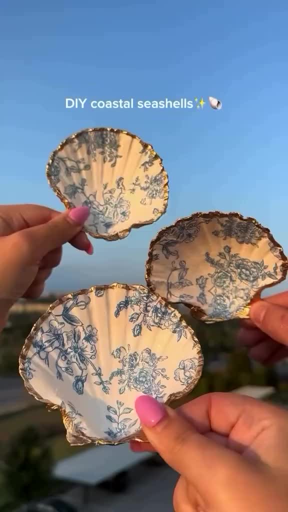 This may contain: two people holding plates in their hands with blue and white designs on the rims