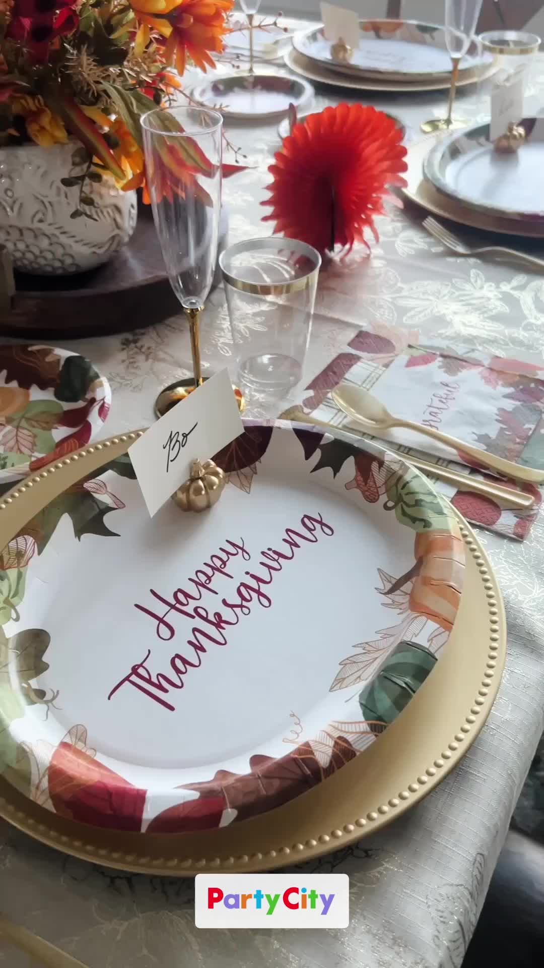 This may contain: a table set with plates and place settings for a thanksgiving dinner or special occasion to celebrate