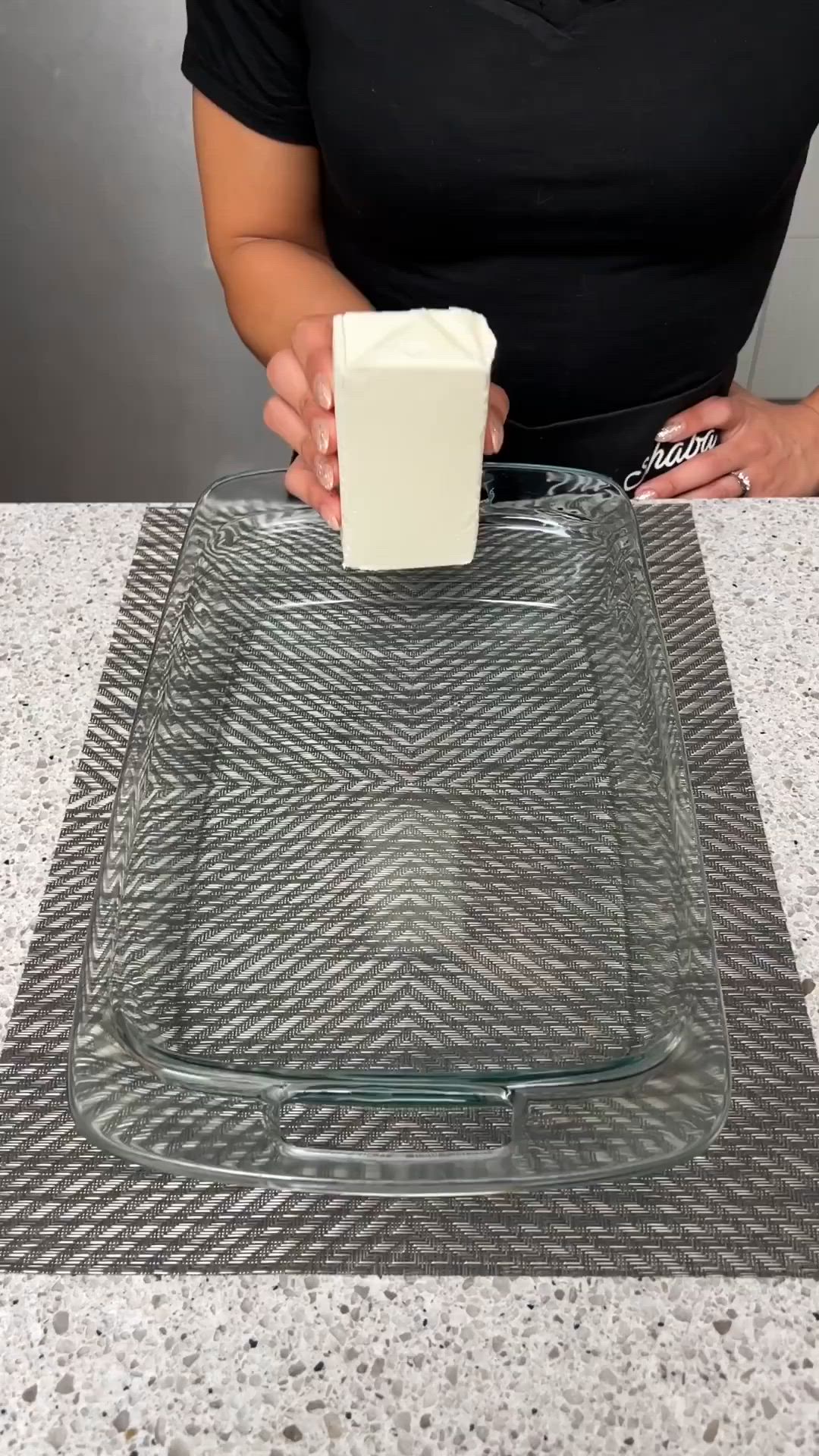 This may contain: a person holding a square object in front of a glass plate on top of a counter