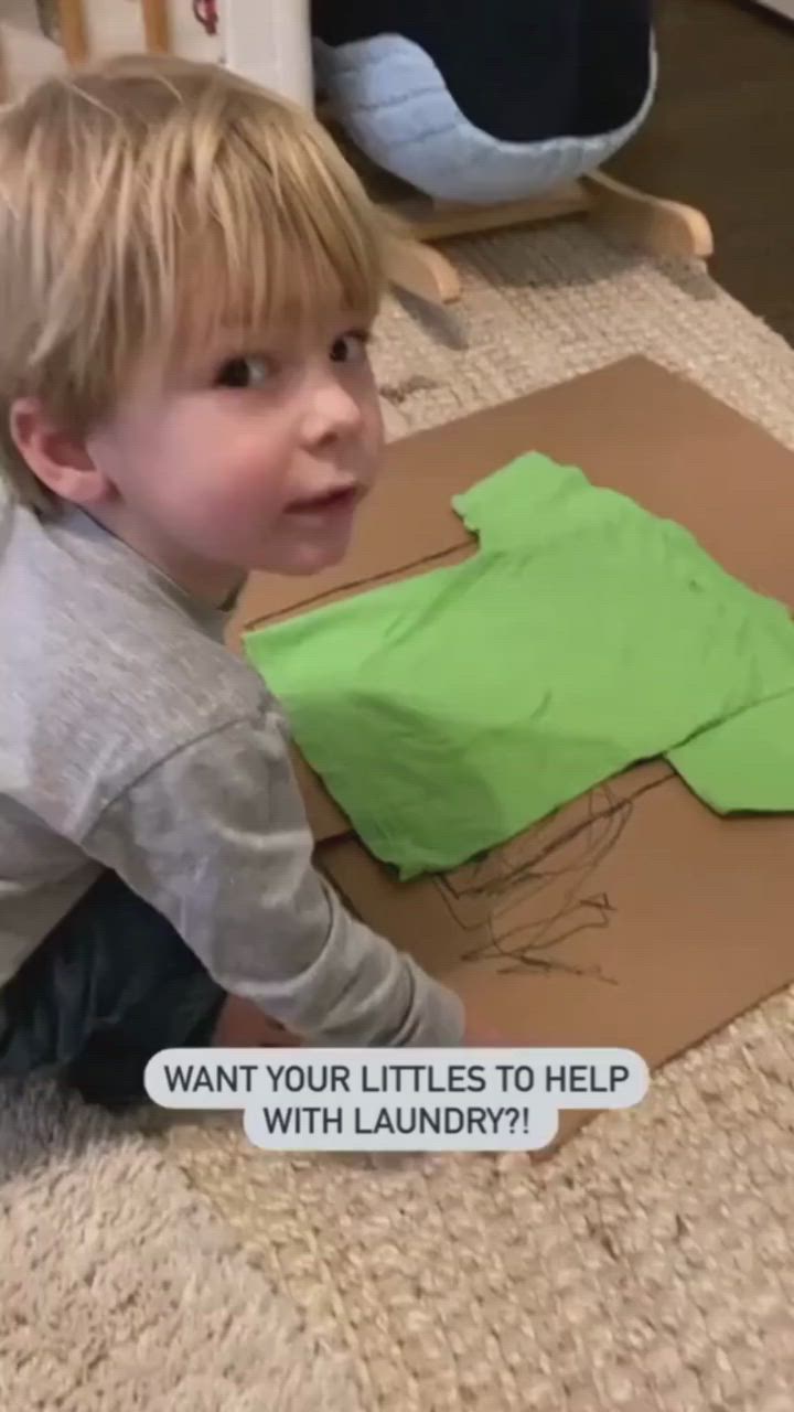 This may contain: a little boy that is kneeling down on the floor with some kind of crafting material