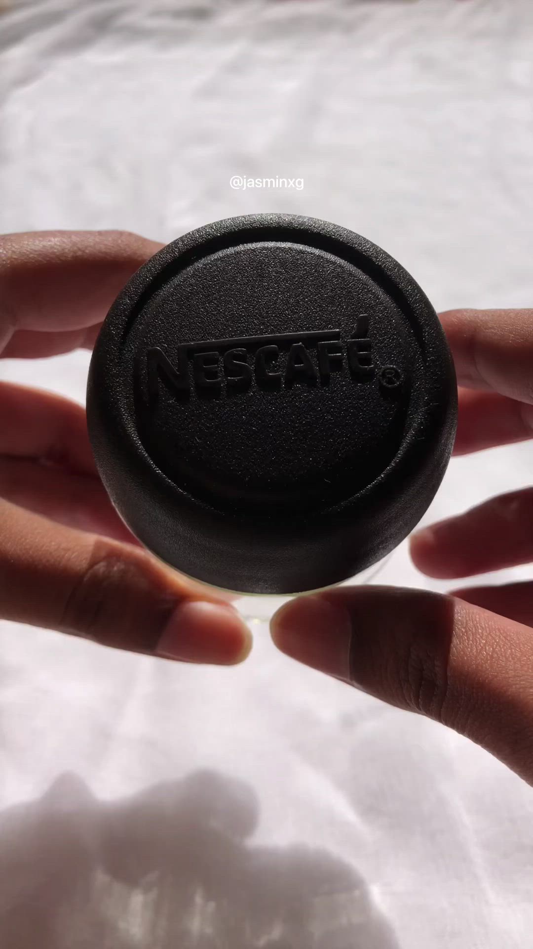 This may contain: a hand holding a black object with the word netaff on it's side