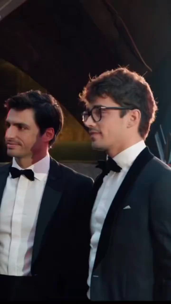 This may contain: two men in tuxedos standing next to each other