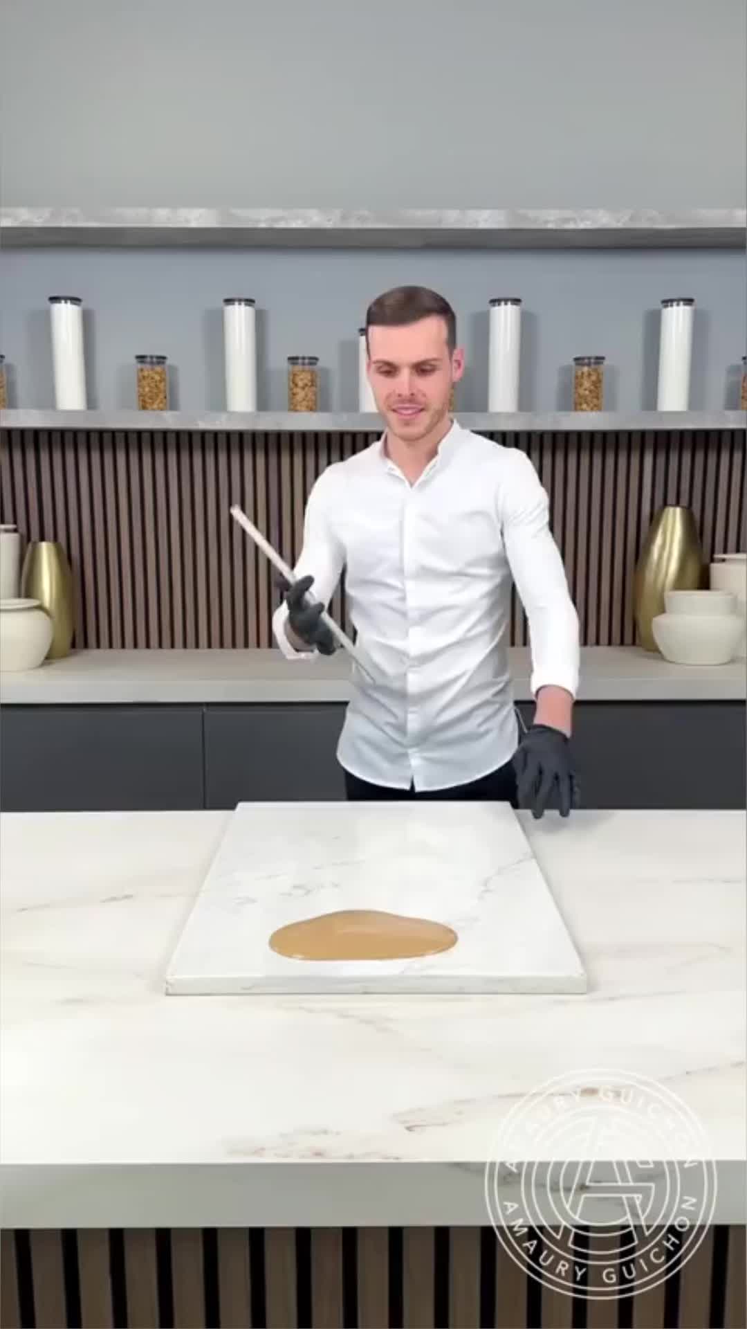 This may contain: a man standing in front of a counter with a knife