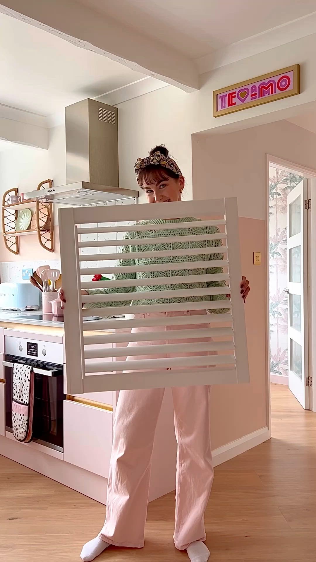 This may contain: a woman is working on a window seal