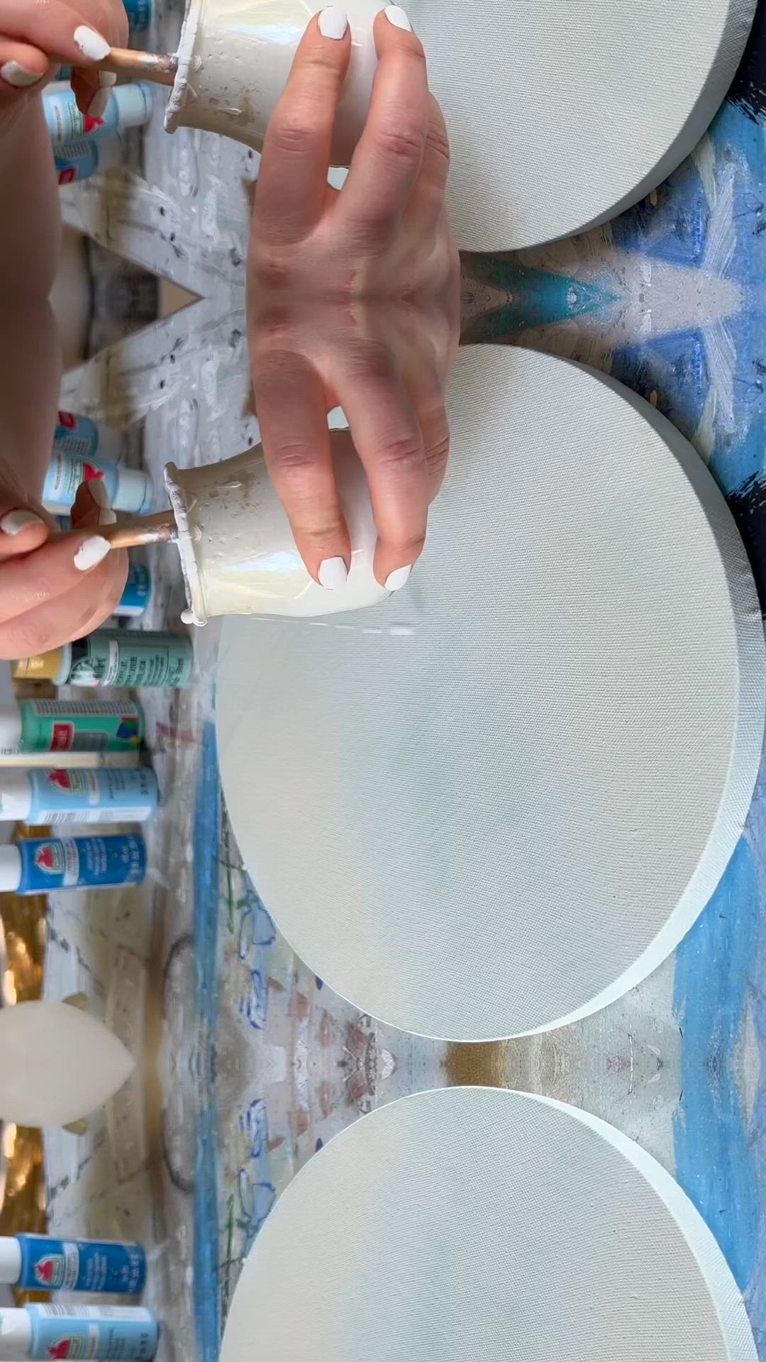 This may contain: someone is painting flowers on a canvas with acrylic paint and an egg in the middle