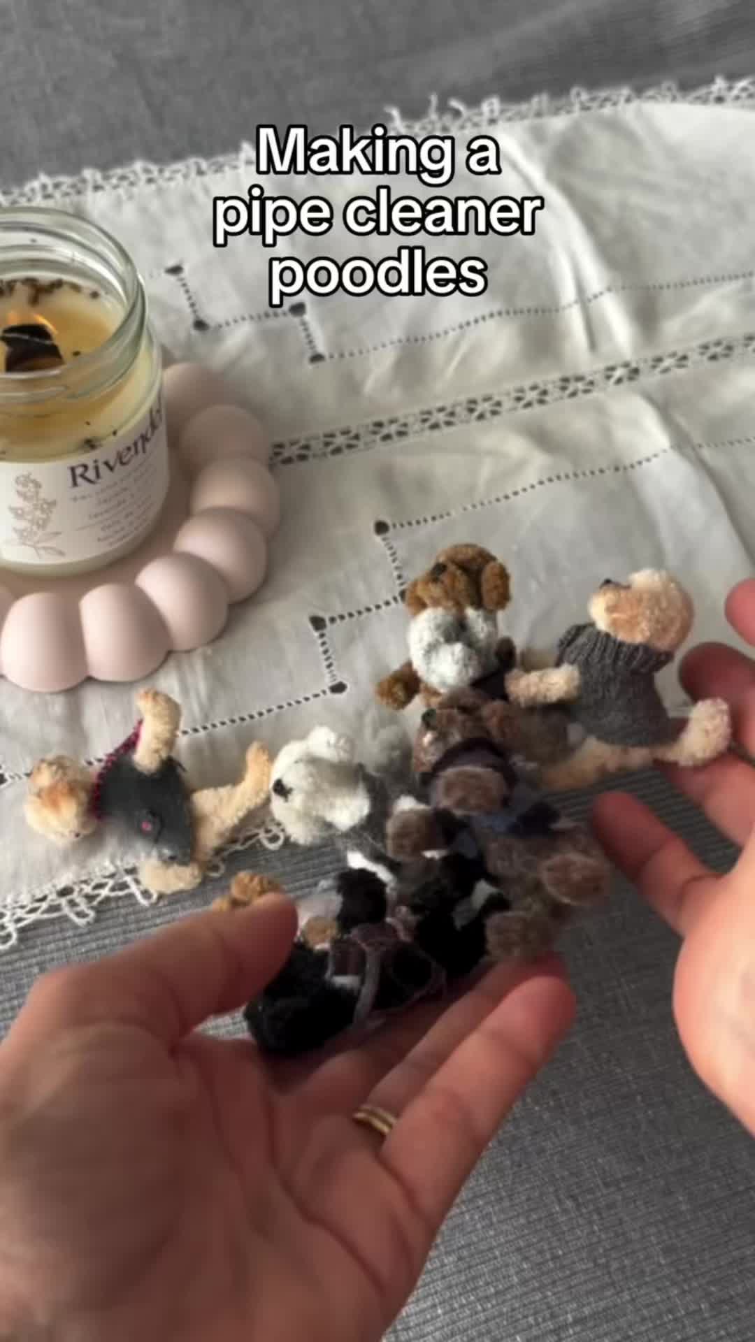 This may contain: someone is making a pipe cleaner poodles out of stuffed animals and other items