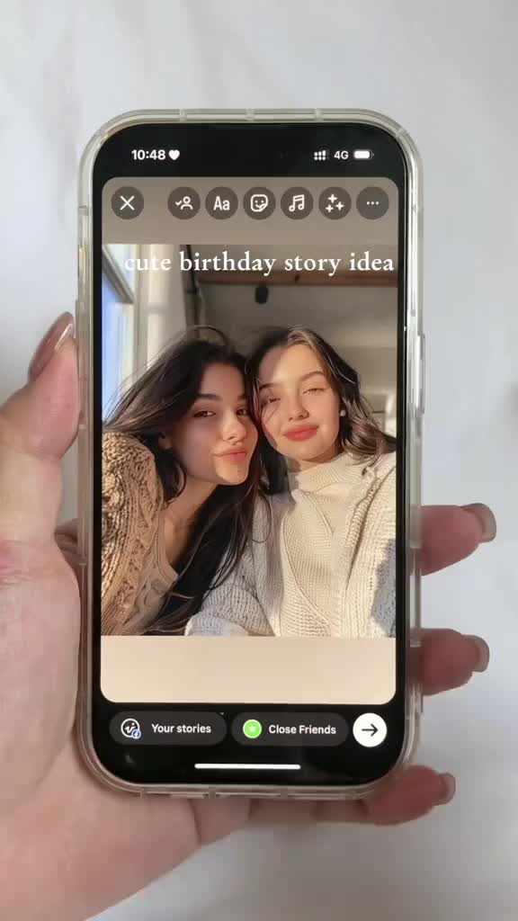 This may contain: someone is taking pictures on their cell phone with the camera attached to it, while another person's hands are holding an iphone