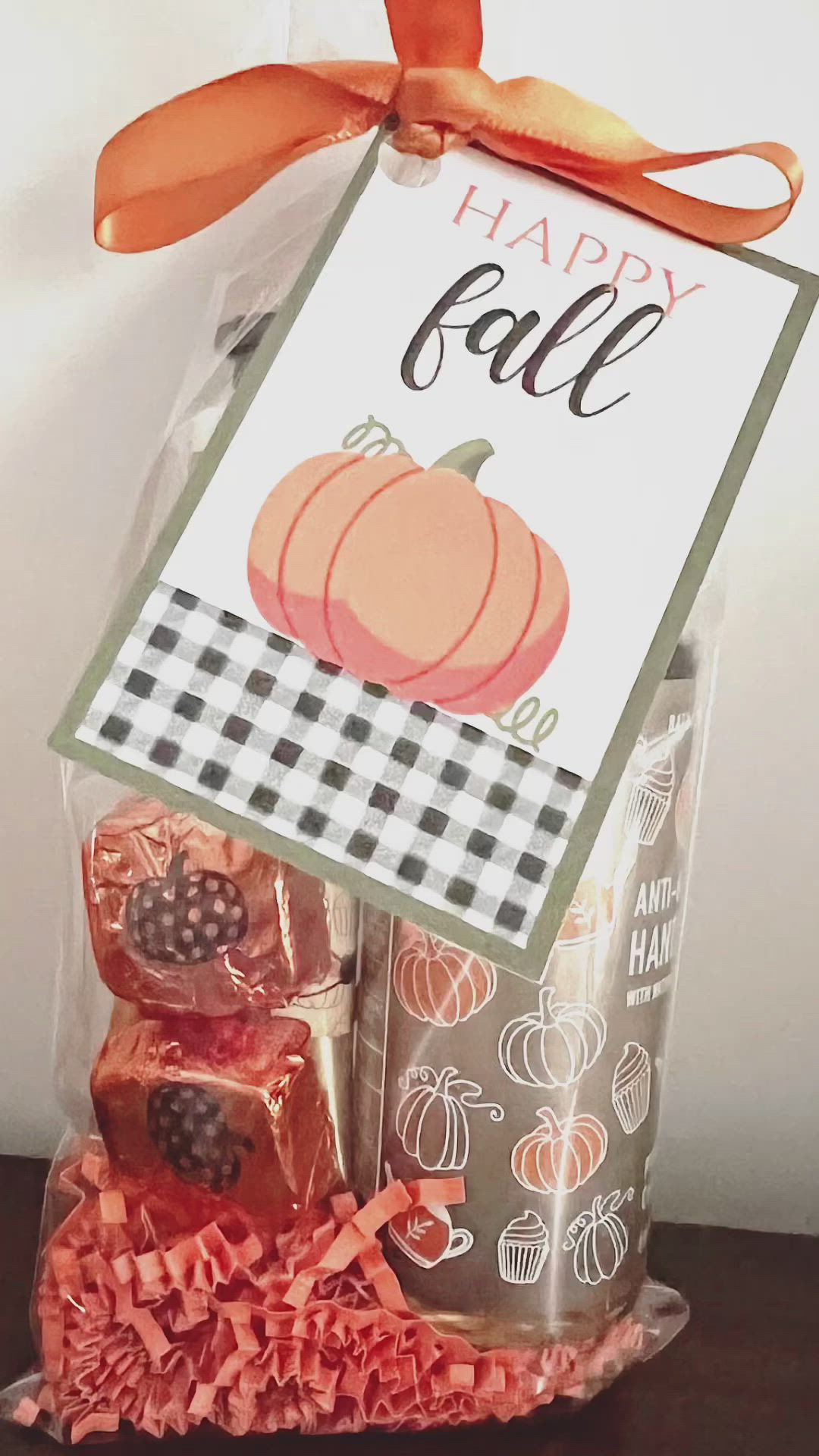 This may contain: an image of a happy fall treat in a bag with ribbon and tag on it