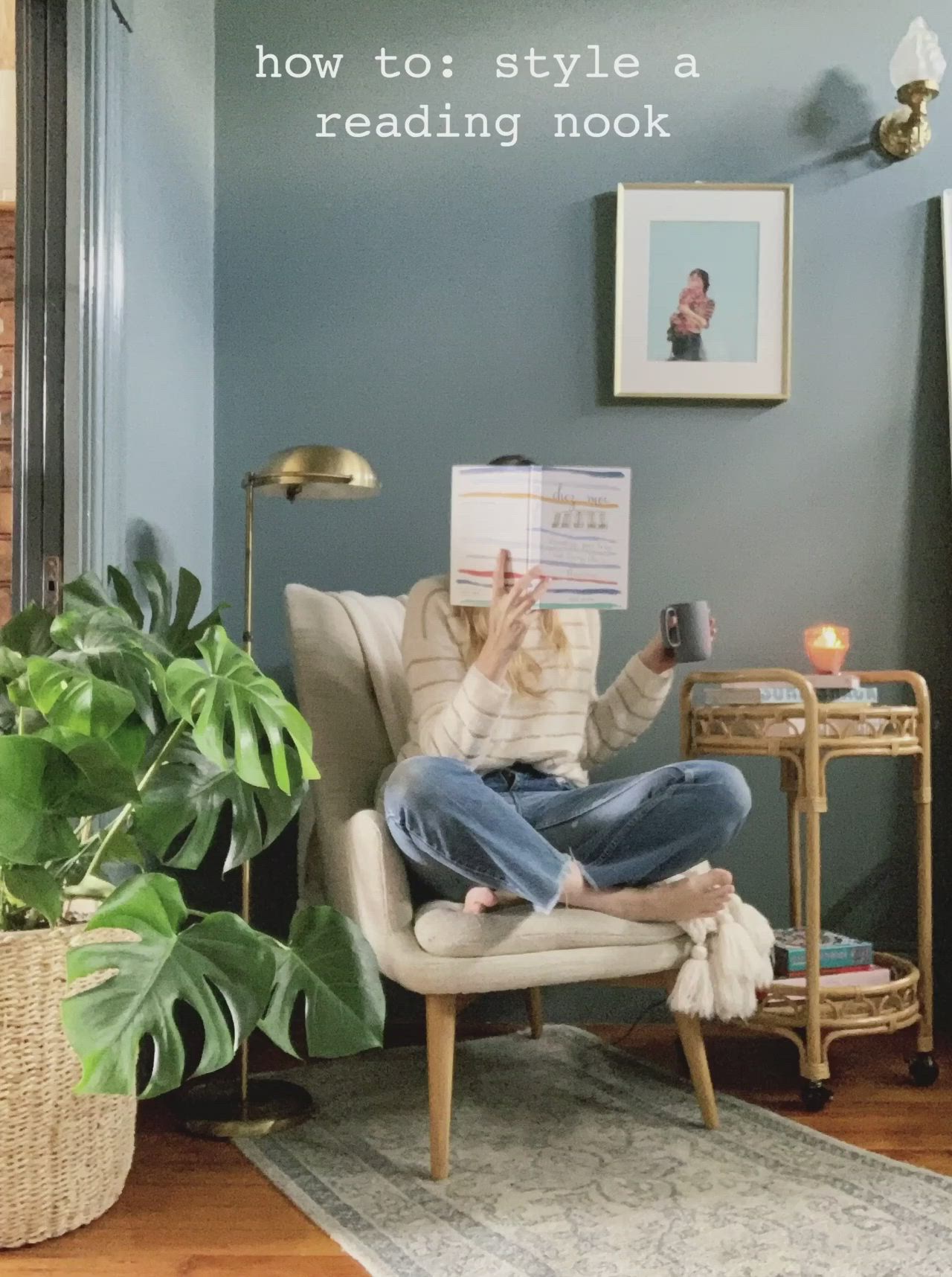 This may contain: a woman sitting in a chair reading a book with the caption how to style a reading nook