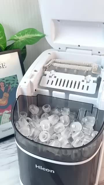 This may contain: an ice bucket filled with water next to a book