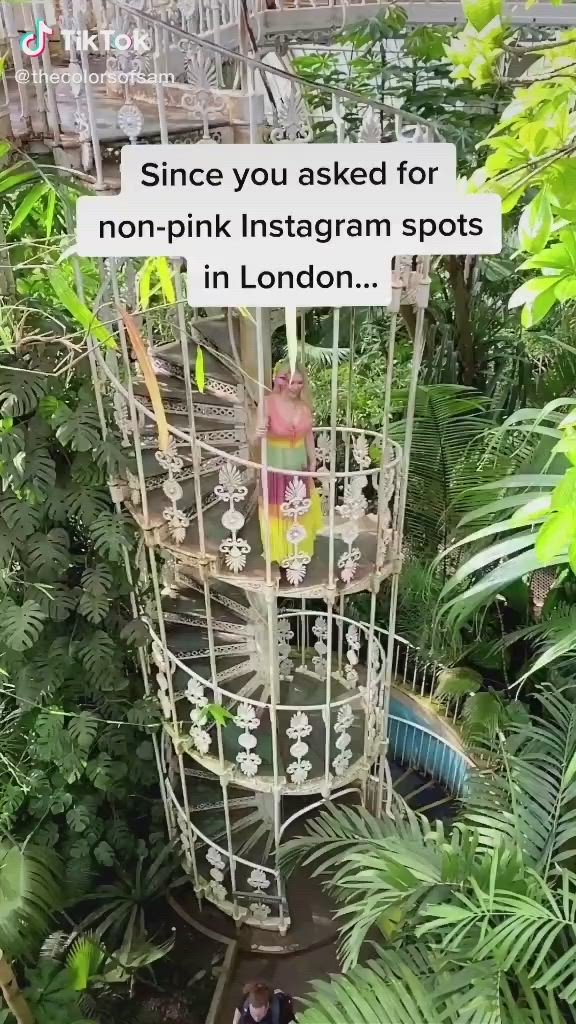 This may contain: there is a spiral staircase in the middle of plants and trees with an ad on it