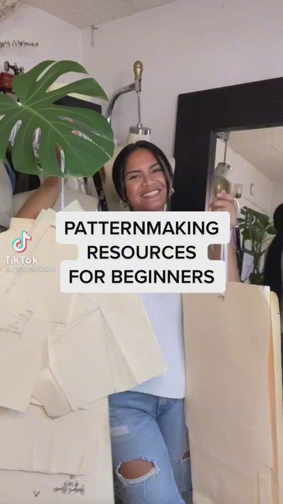 This may contain: a woman holding up some paper bags with the words patternmaking resources for beginners