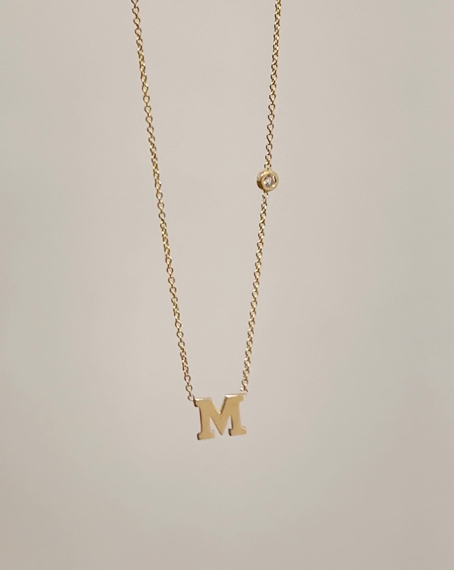 Beautifully handcrafted 14k solid gold initial and a small bezel diamond on a dainty cable link chain necklace. Available in 14k white and yellow gold, this stunning piece will be you new favorite necklace! Wear it with your initial or your loved one's. Size of Initial: Approx. 5mm Diamond Carat Weight: Approx. 0.03 ctw Diamond Clarity: VS Standard Production: 4-9 business days Rush Order Production: 2-5 business days Shipping: Select shipping method at checkout.2-Day Shipping and Overnight ship