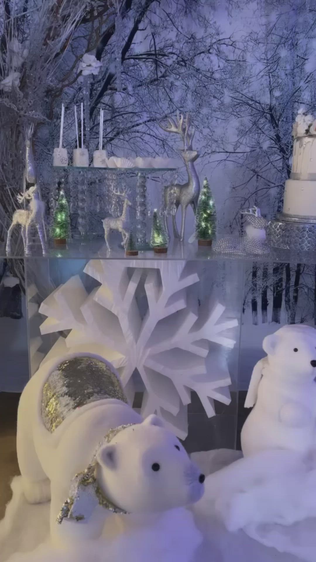 This may contain: an ice sculpture with two polar bears and snowflakes on the table in front of it