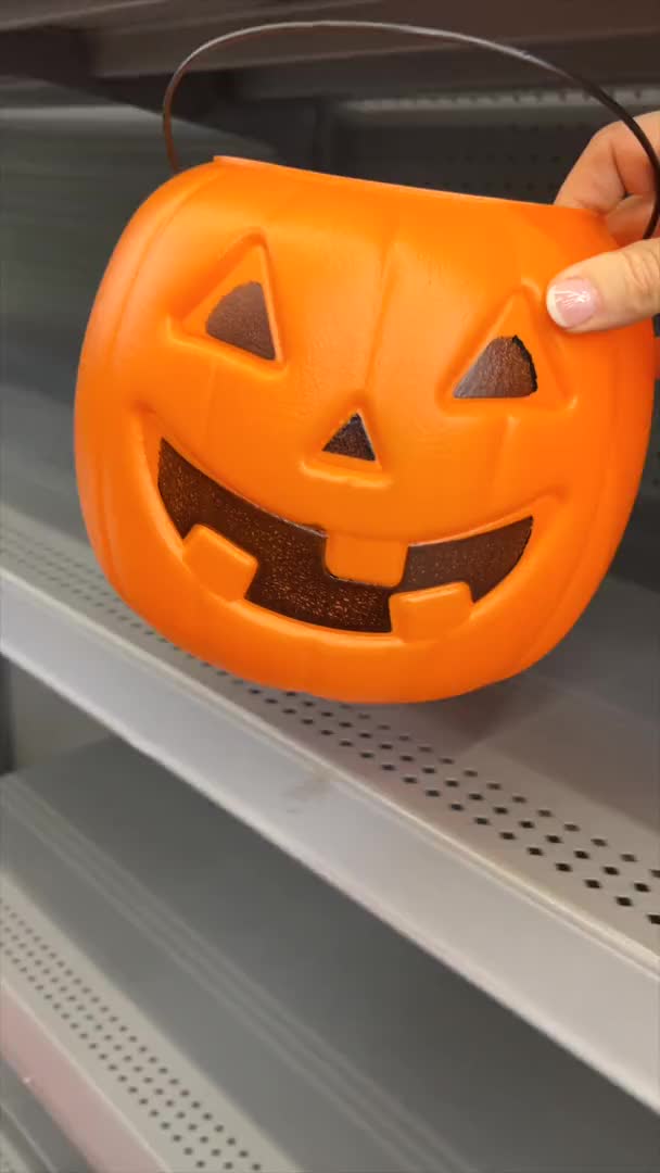 This may contain: a man is decorating a pumpkin shaped table