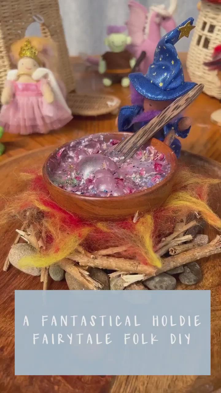 This may contain: a wooden table topped with a bowl filled with liquid and a blue bird figurine