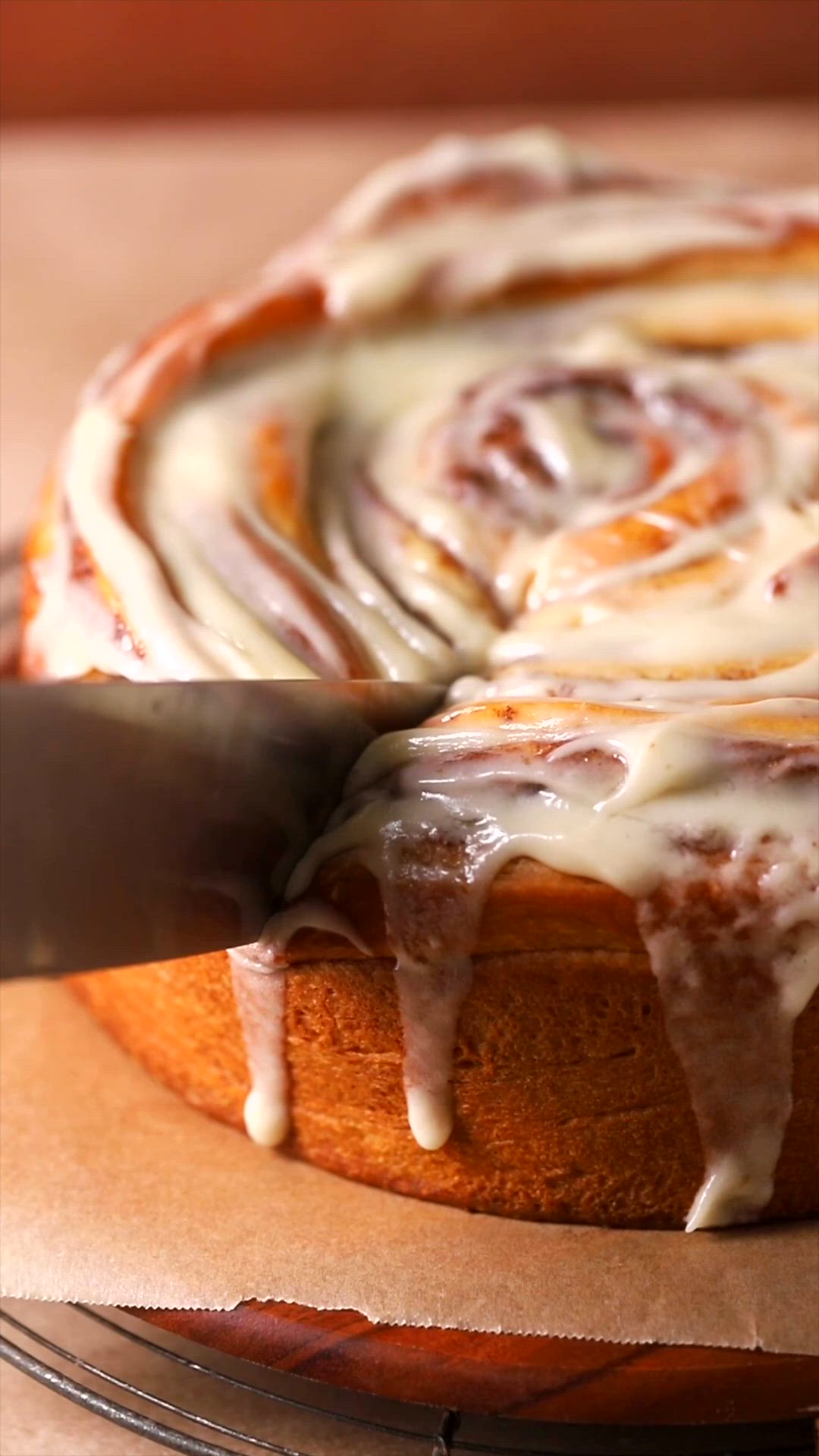 This may contain: a cinnamon roll cake with icing on top