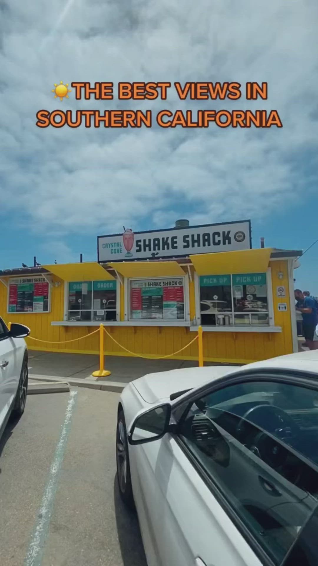 This may contain: two cars parked in front of a yellow building with the words, the best views in southern california