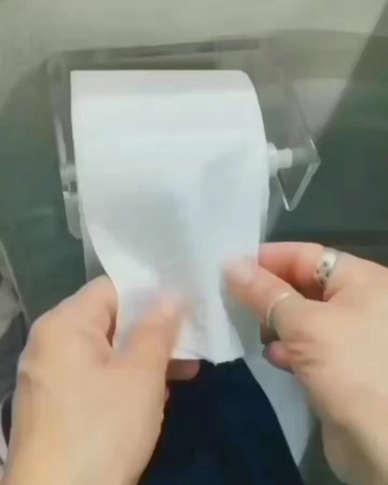 This may contain: two hands holding a piece of white paper