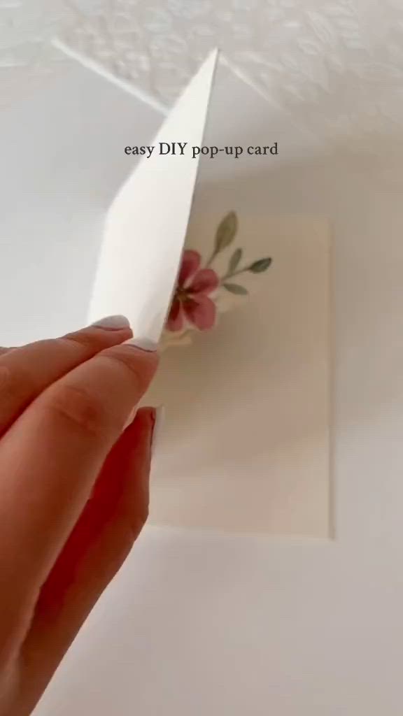 This may contain: an easy diy pop up card with flowers on it