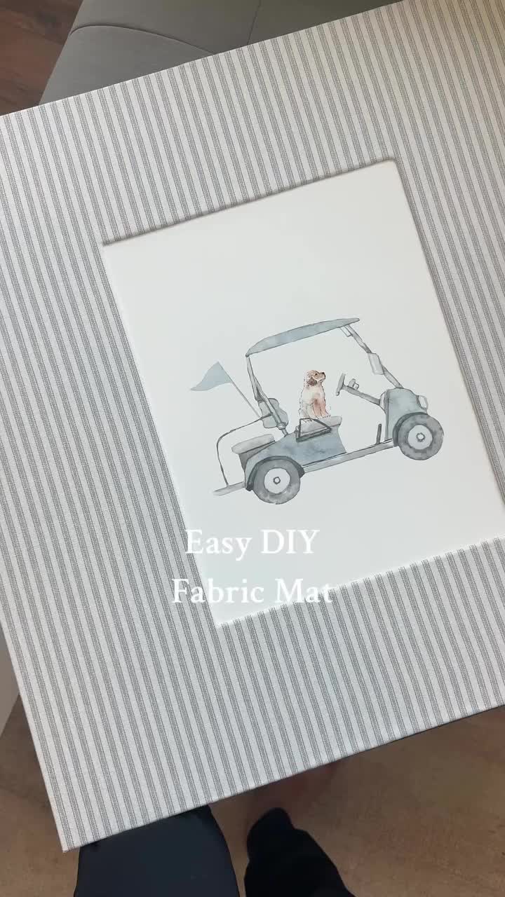 This may contain: a person holding up a card with an image of a golf cart on it