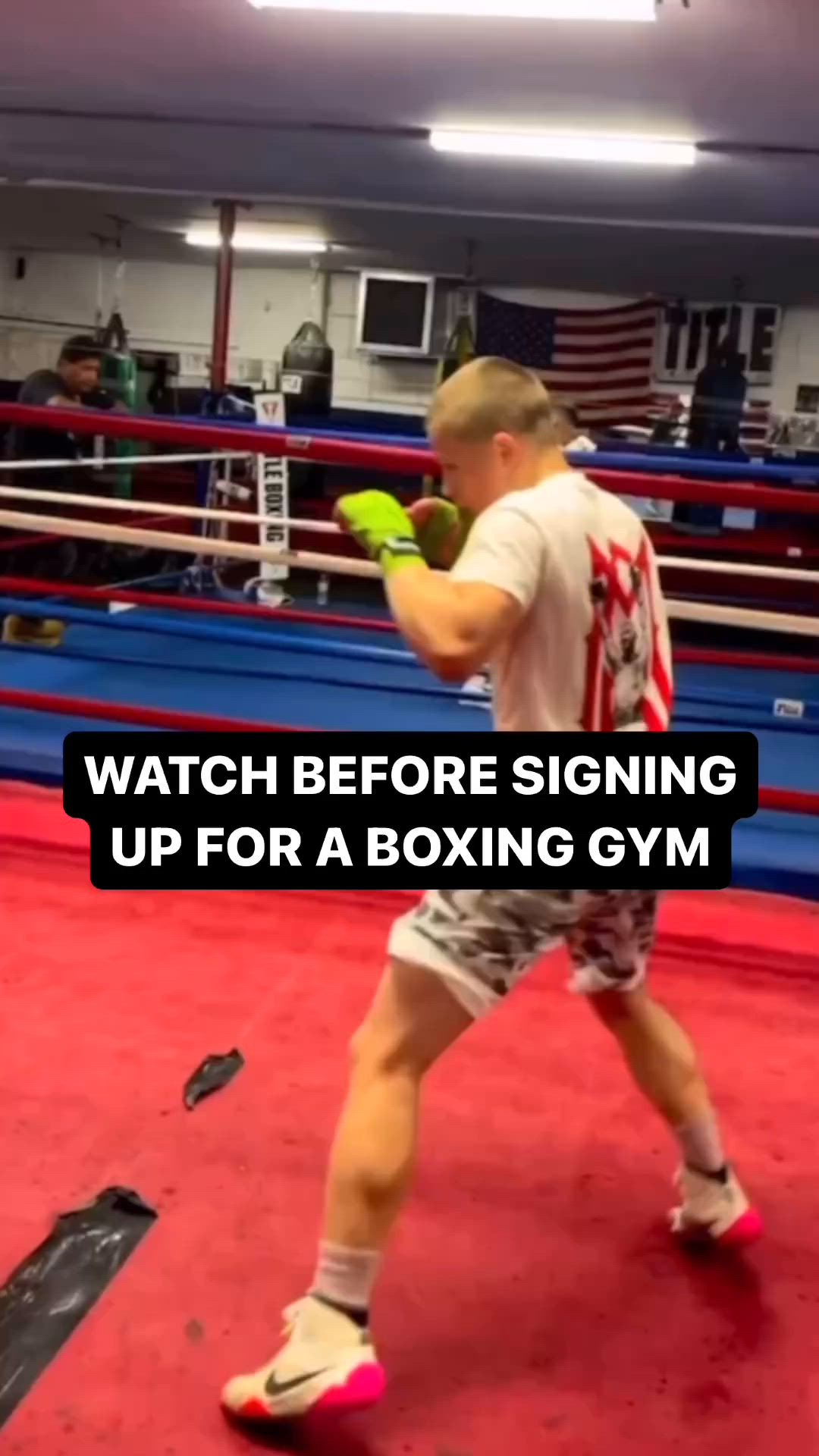 This may contain: a man standing on top of a boxing ring holding a green glove in his hand